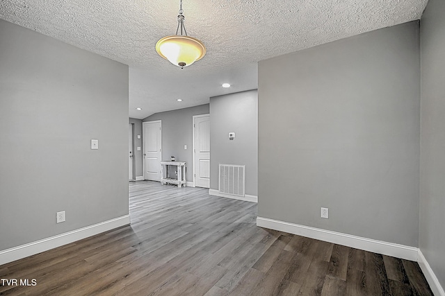 empty room featuring hardwood / wood-style floors and a textured ceiling