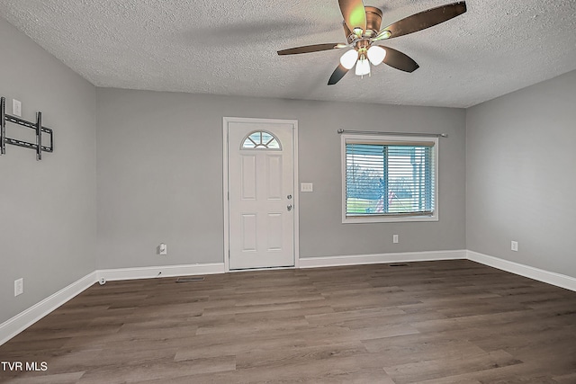 entrance foyer with a textured ceiling, hardwood / wood-style flooring, and ceiling fan