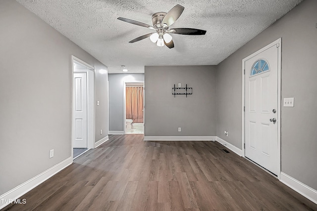 foyer with hardwood / wood-style floors, ceiling fan, and a textured ceiling