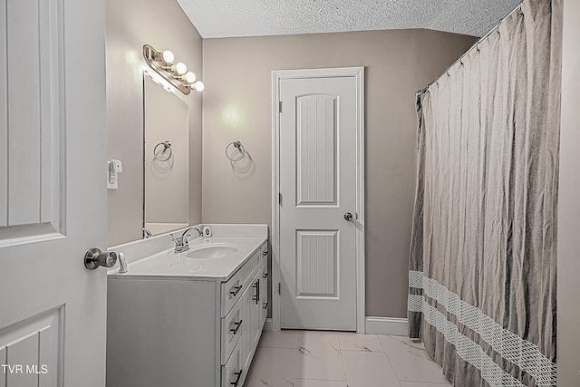 bathroom featuring vanity, a textured ceiling, and a shower with shower curtain