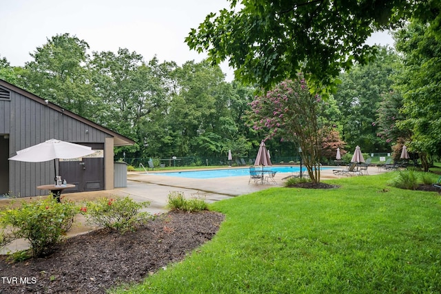 view of pool with a yard and a patio