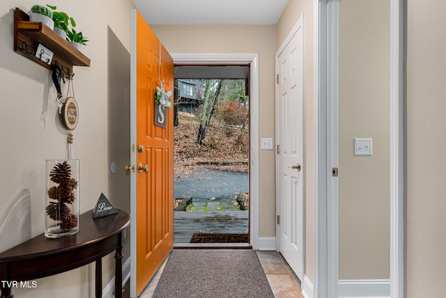 entryway with light tile patterned flooring