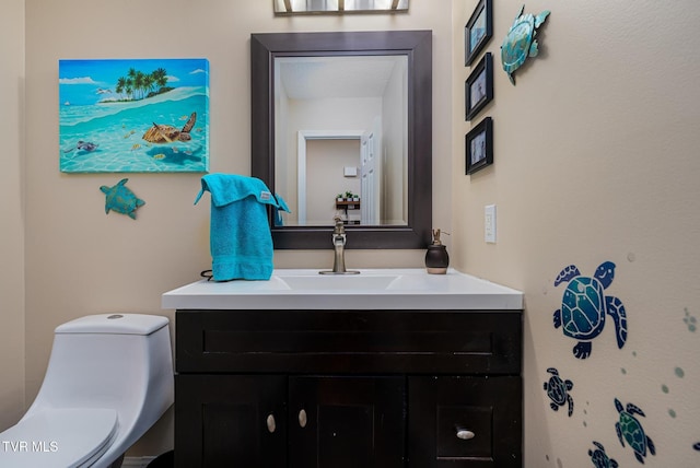 bathroom featuring vanity and toilet