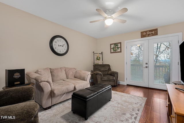 living room with hardwood / wood-style floors, french doors, and ceiling fan