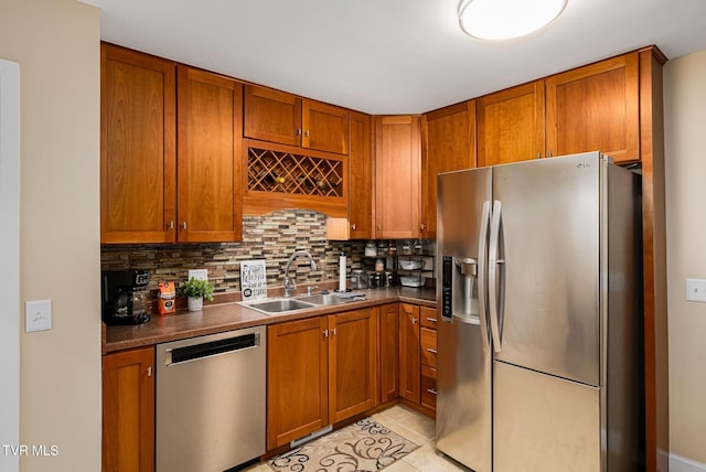 kitchen with light tile patterned floors, backsplash, stainless steel appliances, and sink