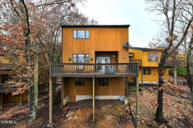 back of house featuring a wooden deck