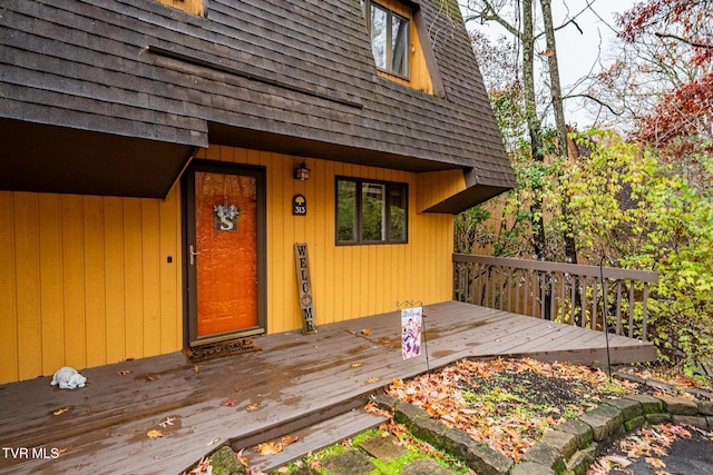 view of exterior entry with a wooden deck