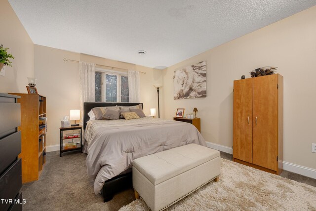 carpeted bedroom featuring a textured ceiling