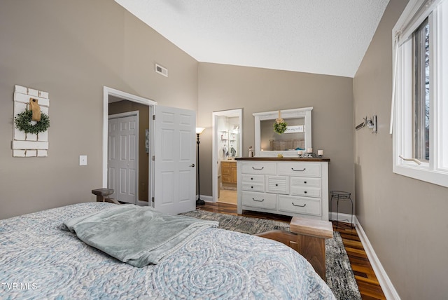 bedroom featuring hardwood / wood-style flooring, ensuite bath, high vaulted ceiling, and multiple windows