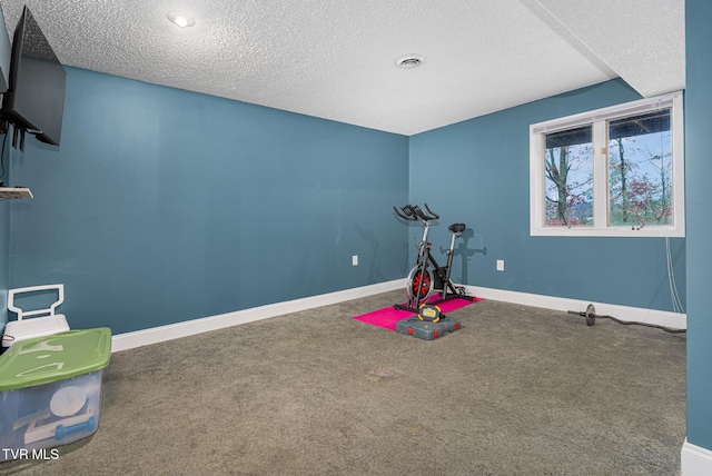 game room featuring carpet and a textured ceiling