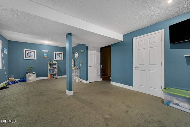 basement featuring carpet floors and a textured ceiling