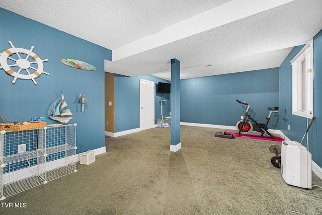 playroom featuring carpet and a textured ceiling