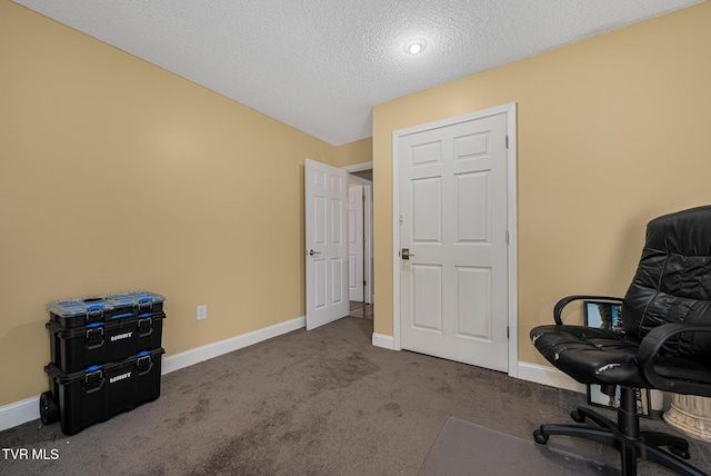 office with dark colored carpet and a textured ceiling