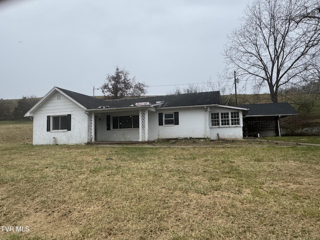 rear view of property with a yard