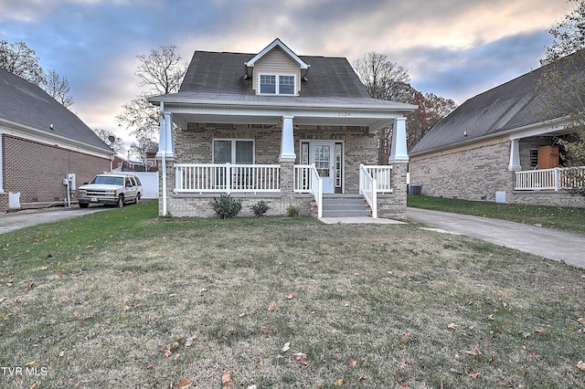 view of front of home featuring a lawn and a porch