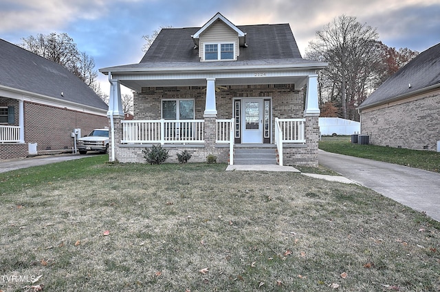 view of front of property with covered porch and a front yard