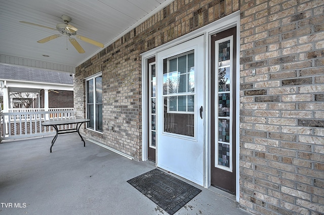 entrance to property featuring ceiling fan and covered porch