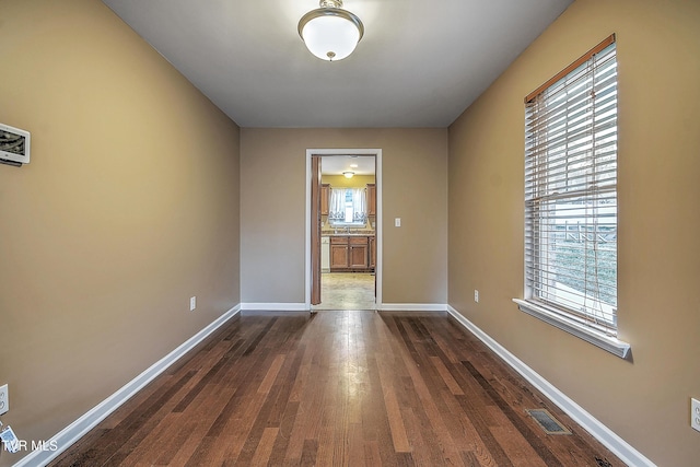 unfurnished room with dark hardwood / wood-style floors