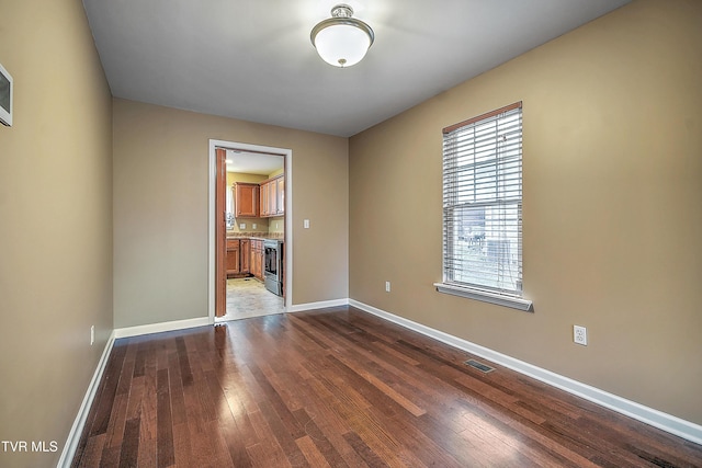 empty room with hardwood / wood-style floors