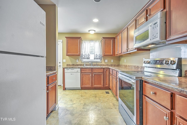 kitchen featuring white appliances and sink