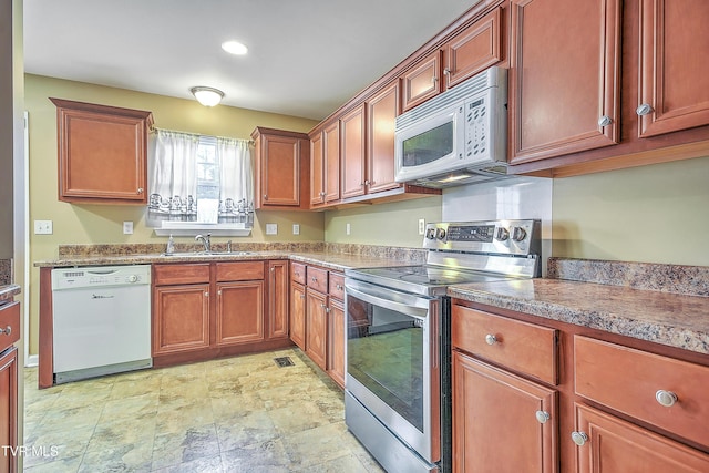 kitchen featuring white appliances and sink