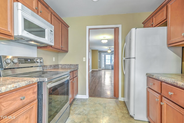 kitchen with ceiling fan, light hardwood / wood-style floors, and white appliances