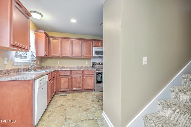 kitchen featuring white appliances and sink