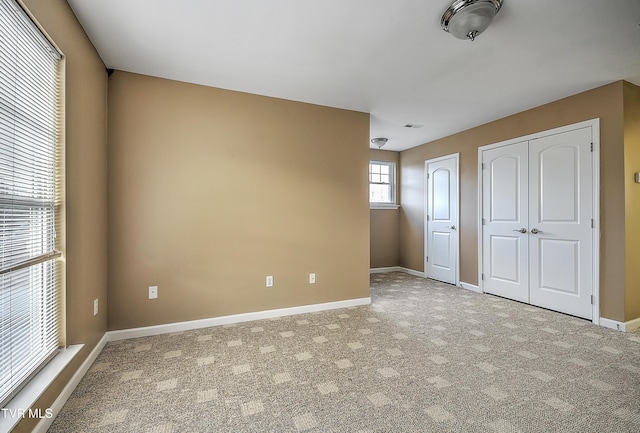 unfurnished bedroom with carpet floors and multiple closets