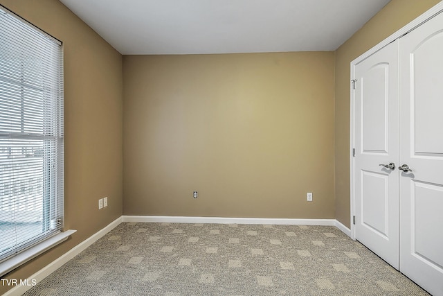 unfurnished bedroom featuring light colored carpet