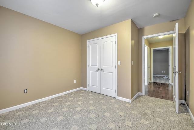 unfurnished bedroom featuring a closet and carpet