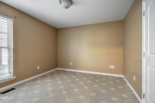 carpeted empty room with plenty of natural light