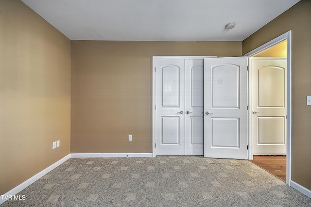 unfurnished bedroom featuring a closet and carpet floors