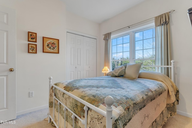 bedroom featuring light colored carpet and a closet