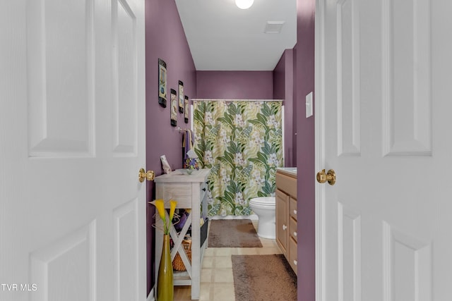 bathroom with tile patterned flooring, vanity, a shower with shower curtain, and toilet