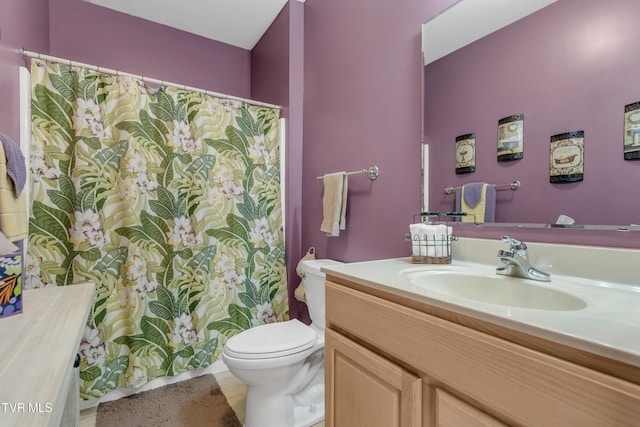 bathroom featuring tile patterned floors, vanity, and toilet