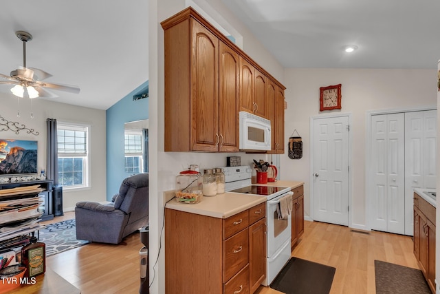 kitchen with white appliances, light hardwood / wood-style floors, ceiling fan, and lofted ceiling