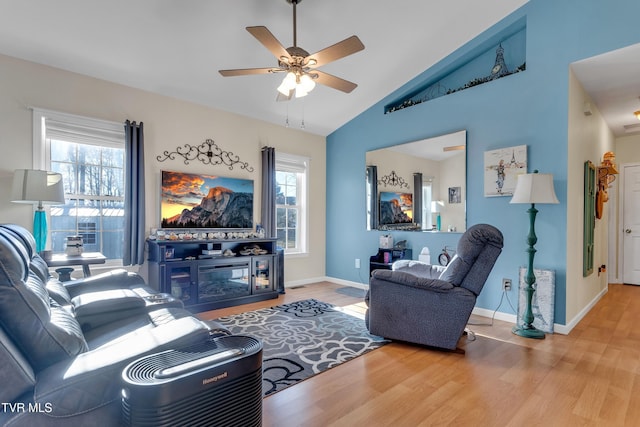 living room with hardwood / wood-style floors, plenty of natural light, and vaulted ceiling