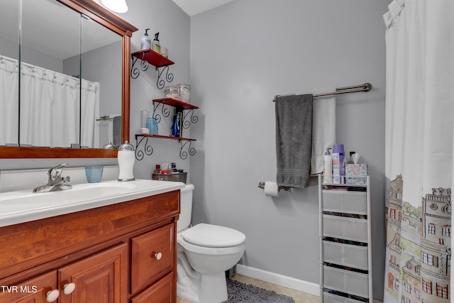 bathroom featuring toilet, vanity, and tile patterned floors