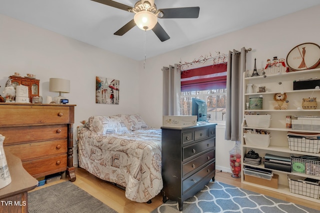 bedroom with light wood-type flooring and ceiling fan