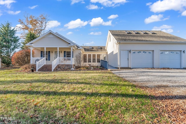 single story home with covered porch, a garage, and a front yard