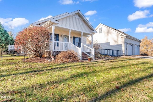 view of front of house with a front lawn, covered porch, and a garage