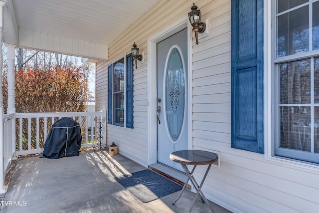 view of exterior entry with covered porch