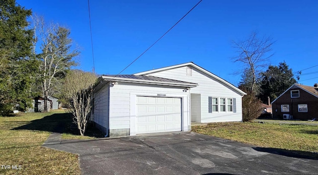 exterior space with a garage and a front lawn