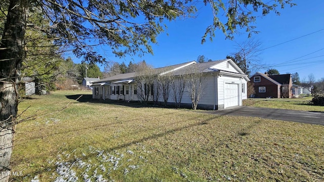 view of side of property with a lawn and a garage