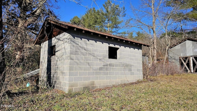 view of side of home featuring a storage unit