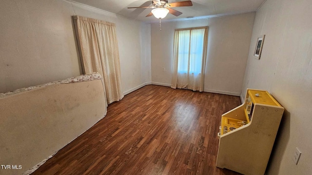 unfurnished room with crown molding, dark hardwood / wood-style flooring, and ceiling fan