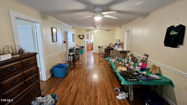 game room with ceiling fan, wood-type flooring, and crown molding