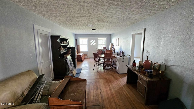 interior space with wood-type flooring and a textured ceiling