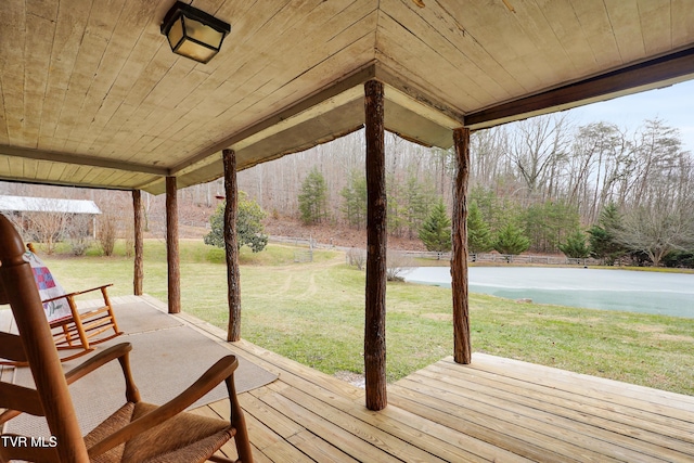 wooden terrace featuring a lawn