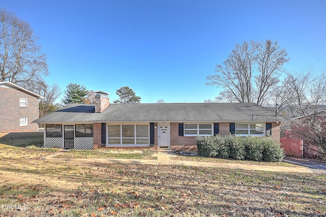 ranch-style home with a front lawn